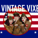 Three women in vintage military uniforms pose in front of a stylized American flag with text reading "The Vintage Vixens.